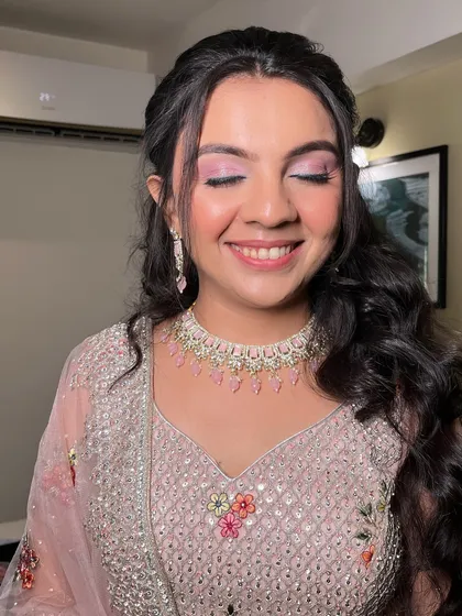 A detailed shot of the eye makeup. The soft pink shimmer makes her eyes pop, creating a romantic and dreamy effect perfect for an engagement.