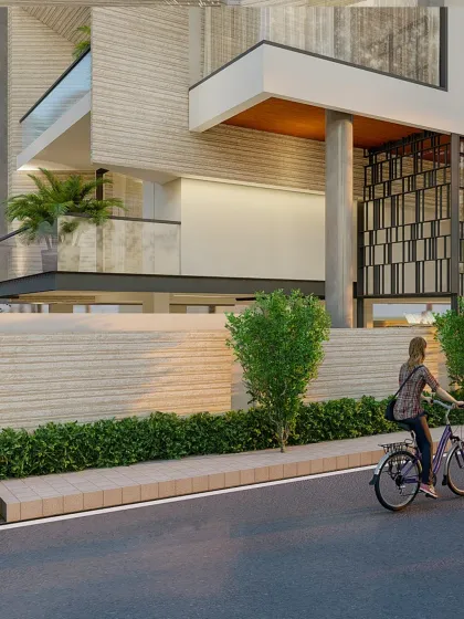 This view highlights the textured materials used on the boundary wall and lower levels of the facade, grounding the structure and connecting it to the streetscape.