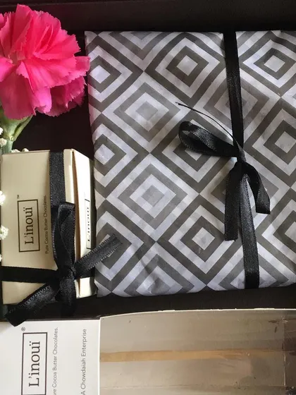 An inside look at one of our curated gift hampers, complete with chocolates and other goodies, all exquisitely wrapped. This is a perfect option for corporate gifting or employee appreciation.