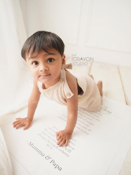 On the move. This little guy is exploring his birthday banner, a sweet message from mom and dad.