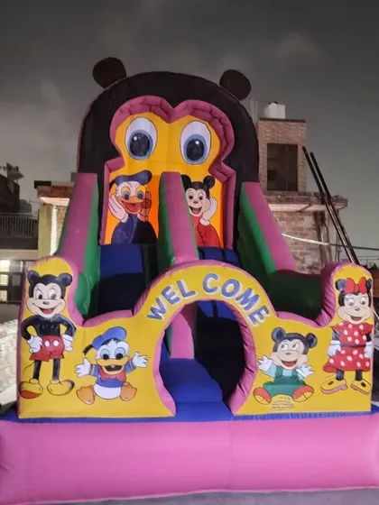 A clear look at our Mickey Mouse themed bouncy house at night. The characters are all hand-painted, and the "Welcome" arch makes it very inviting for kids at an evening party.