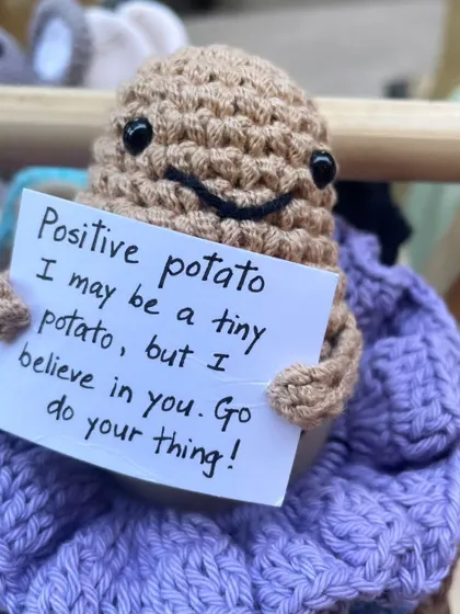 A close-up of the 'Positive Potato' sitting among my other creations. It's a small item, but it carries a big, positive message that I love sharing with others.