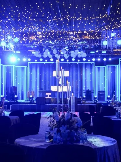 The view from the back of the dining area, looking towards the high-energy DJ stage with its dynamic lighting and starry ceiling.
