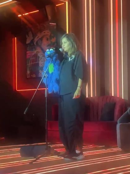 Performing with Jack at a comedy club in Dubai. The neon-lit stage and intimate setting create a great vibe for stand-up.