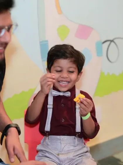 A father and son sharing a happy, candid moment during the party.