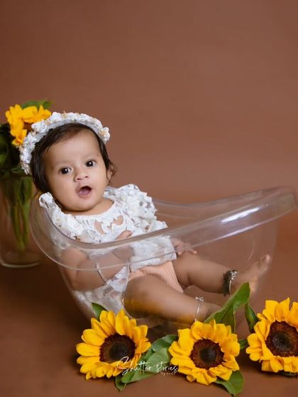 A wider shot of the sunflower bathtub setup, showing the simple and beautiful composition against a brown backdrop.