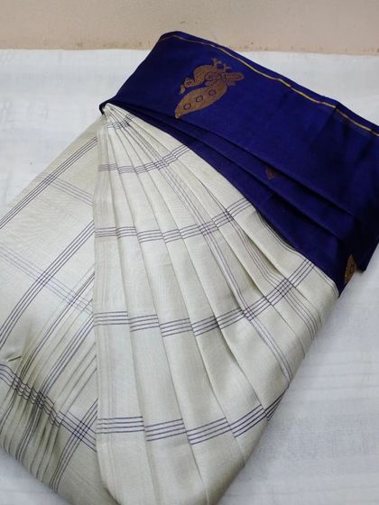 This elegant off-white and blue saree is perfect for formal events. My pre-pleating service makes draping it an easy and graceful process.
