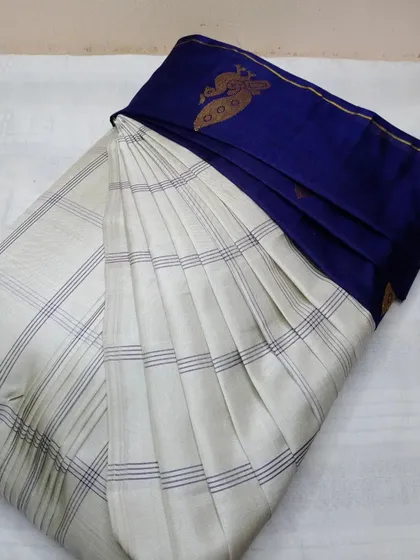 An elegant off-white and blue silk saree, pleated for an easy and graceful drape.