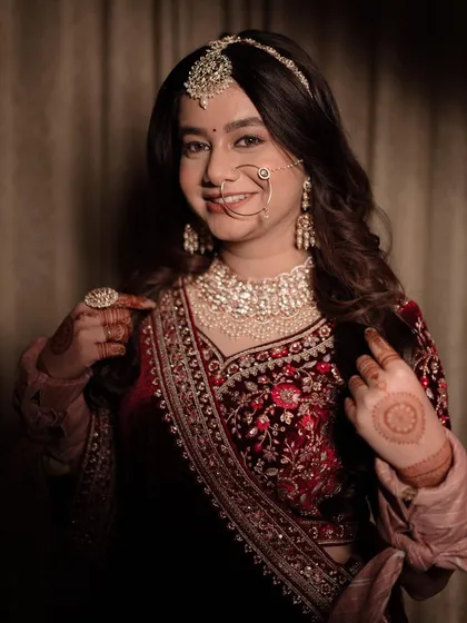 A close-up portrait showcasing the bride's beautiful smile, intricate henna, and stunning jewelry. I focus on capturing the details that make your bridal look unique.