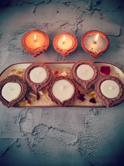 A set of my Diya Candles, shown here in a pure white wax before being lit. The simple elegance of the terracotta diyas combined with the clean soy wax creates a peaceful and divine atmosphere.