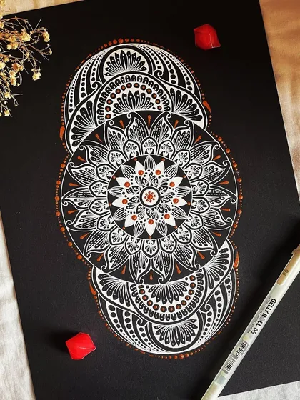 A different take on the classic mandala, this piece uses a unique three-part structure. The white and bronze gelly roll pens create a sophisticated and modern look on the black paper, perfect for a contemporary space.