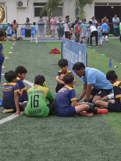 A coach giving instructions to our youngest players during the Blue Cubs League. Building a strong foundation of confidence and discipline from an early age.