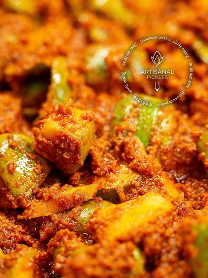 A close-up look at the rich texture of our artisanal Khatti Keri Mustard pickle. You can see the chunks of mango perfectly coated in our freshly ground spice blend.