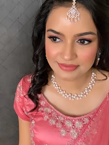A beautiful profile shot of my client, ready for her ring ceremony. The soft pink makeup and elegant half-up hairstyle with loose curls create a look that is both modern and timeless.