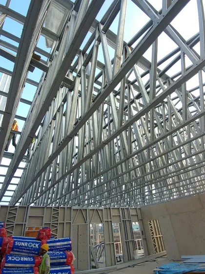The interior of an industrial complex under construction, showcasing the massive steel truss structure I designed. This image demonstrates my capability in handling large-scale structural engineering and industrial architecture projects.