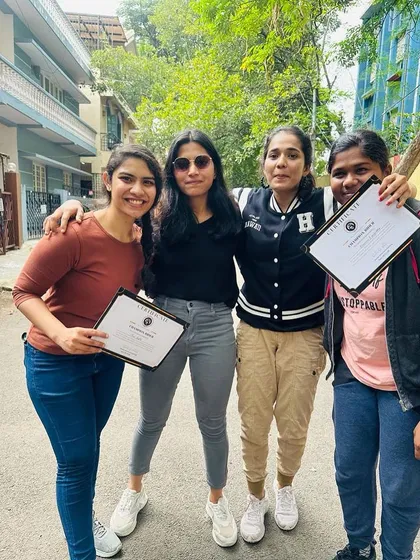 A group of friends show off their certificates. They have successfully completed the training and are now official riders.