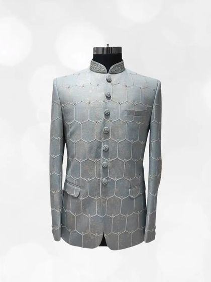 A modern take on a classic, this grey Jodhpuri suit showcases a geometric honeycomb pattern. It's a sophisticated and stylish option from our pre-loved menswear.