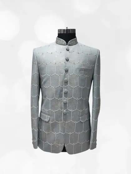 This grey Jodhpuri suit features a unique geometric honeycomb pattern, giving it a structured and contemporary feel. It's perfect for the man who appreciates modern design.