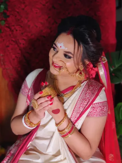 My beautiful Bengali bride Nishita, with her 'alta' decorated hands and classic red bindi.