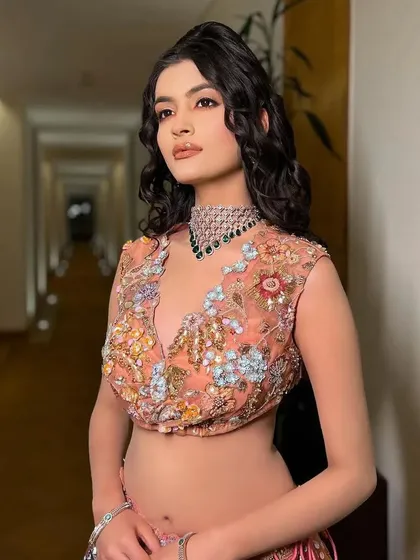 A side profile of the multi-colored lehenga. The styling highlights the intricate floral embroidery on the blouse.