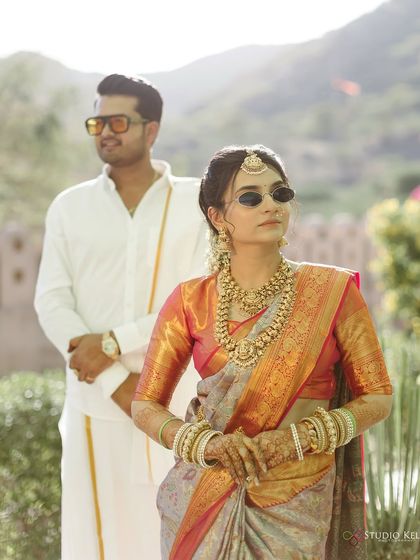 A modern take on royalty, with the couple sporting sunglasses with their traditional South Indian attire. This shot at a palace in Pushkar shows how we can blend tradition with a bit of 'desi' swag.