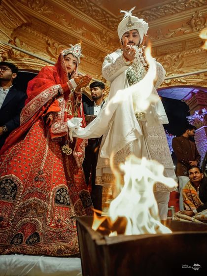 The sacred fire as witness to their union. This shot captures the couple during the phera ceremony, a deeply traditional and meaningful moment in a Hindu wedding.