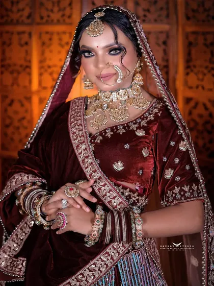 A confident portrait of the bride looking directly at the camera, her hands clasped gracefully.