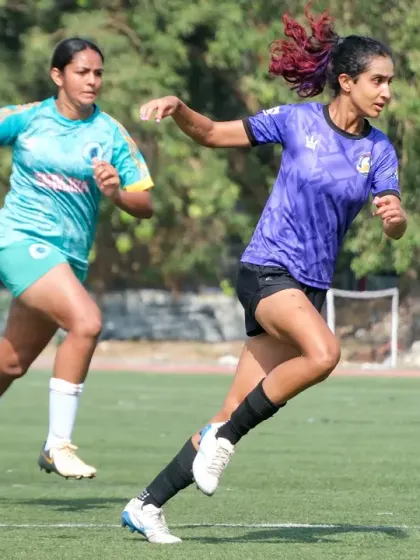 A player in our purple kit dribbling past an opponent, showcasing speed and control.