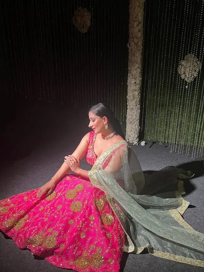 A full view of this vibrant pink lehenga look. The makeup is glamorous enough for a wedding event but still feels youthful and modern.