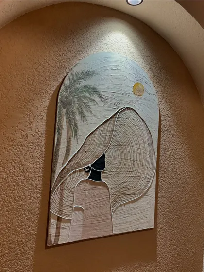 This arched 3ft x 2ft textured piece was created for Seezen cafe in Kanpur. The artwork, featuring a stylized figure, is designed to fit perfectly within the wall niche.