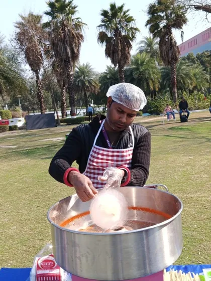 My operator skillfully spinning a cloud of cotton candy. I handle the entire process, from setup to serving, so you don't have to worry about a thing.