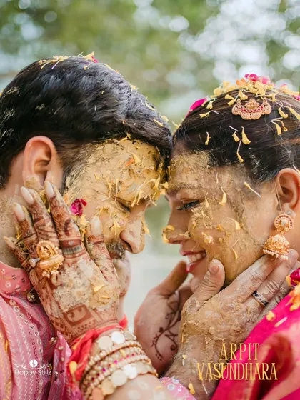 A beautiful, intimate moment amidst the fun of the haldi ceremony. Arpit and Vasundhara, covered in haldi, share a look of pure love and happiness.