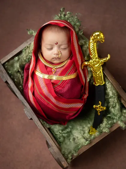 Another angle of the Jijabai theme, highlighting the golden sword prop placed carefully beside the sleeping baby. Safety is always my first priority when using any props.