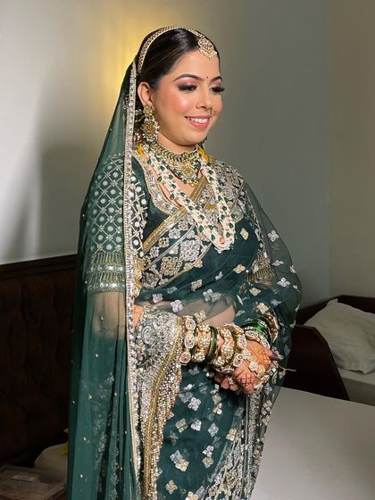 A happy bride, her smile shining as brightly as her beautiful jewelry. Her classic hairstyle completes the look.