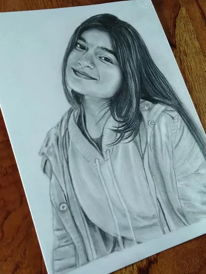 A casual portrait of a young woman in a hoodie. I can create a realistic sketch from any of your favorite photos.