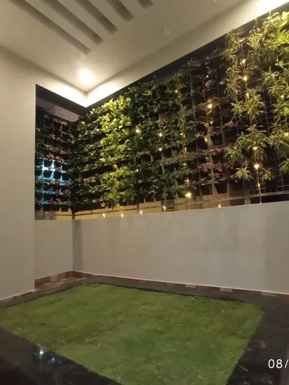 Even compact spaces can become a green sanctuary. We designed and installed this extensive vertical garden, or living wall, complemented by a patch of soft lawn and ambient lighting for a stunning evening view.