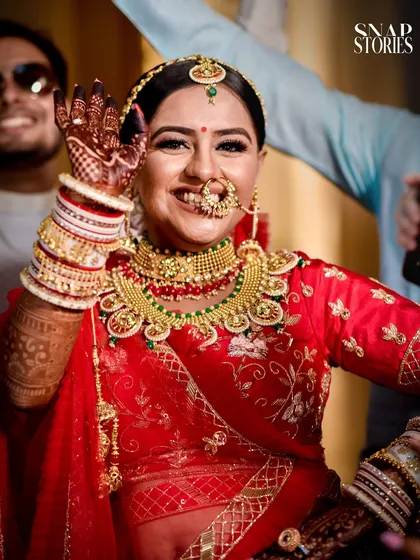 A bride's ecstatic wave to her family and friends. We love capturing these moments of pure happiness and excitement.