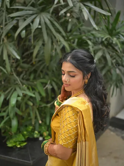 A side profile of the bride-to-be, her hair in soft waves, perfect for a romantic engagement look.