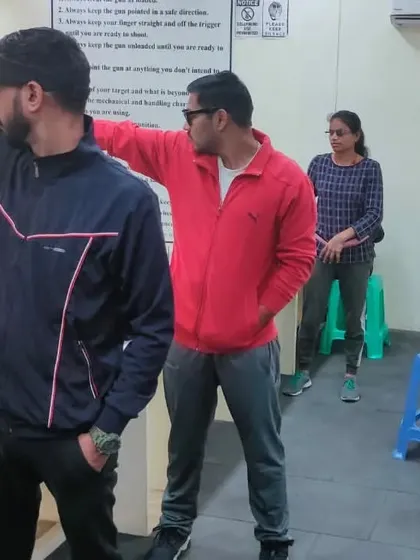 An air pistol shooter receives a technical correction from a fellow senior shooter during a friendly match. We encourage a collaborative learning environment.