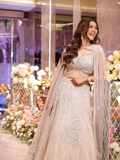A candid moment of laughter from a Sangeet night. Her makeup is a perfect example of soft glam, with a luminous base and defined eyes that look beautiful in the festive lighting.