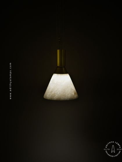 A simple yet elegant cone-shaped pendant light. The shade is crafted from marble, providing a warm, diffused downlight that is perfect for task lighting over kitchen counters, reading nooks, or as accent lighting.