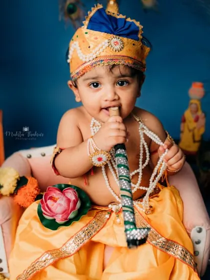 Posing with his flute, this little Krishna is ready to charm everyone. The details in the costume and props make the shoot special.