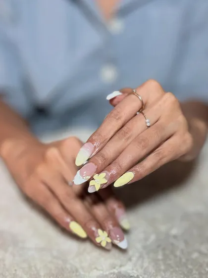 Another angle of the yellow 3D floral design, showing how the art looks on different nails. Consistency across the set is a mark of a pro.