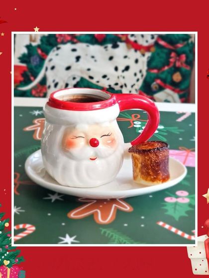 A smiling Santa mug filled with our velvety hot chocolate. It’s a cheerful way to enjoy the holiday spirit and warm up on a cold day.