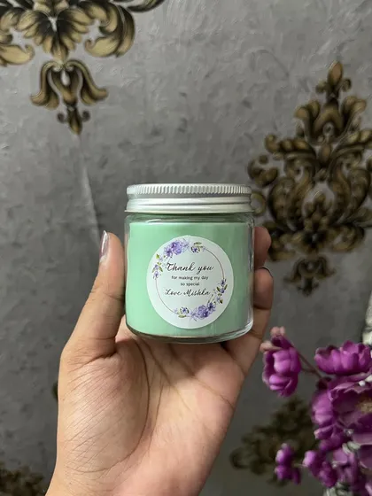 A pastel green custom candle for a birthday return favor. We can match any color palette.
