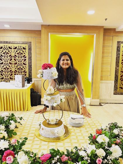 Our founder Sanjana, beaming with pride next to one of her wedding cake creations. We feel so grateful to be a part of your biggest moments and pour our hearts into every detail.