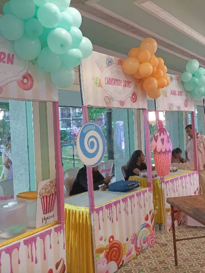 Themed food stalls for a Candyland party. I can even help decorate the food areas, like these popcorn and candy floss counters, to match the overall theme perfectly.