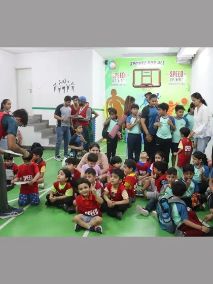 A candid moment during the certificate distribution. The excitement and anticipation are visible on the kids' faces.