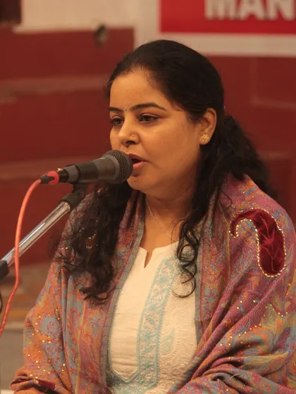 A student presenting her music with devotion and focus at the 'Swarveni Aradhana'.