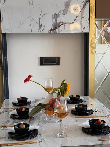 Another perspective of the dining table decor, highlighting the floral arrangement and the quality of the materials used in this custom furniture piece.